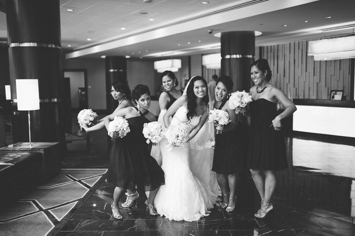 Bridal party walks down the lobby at the Hyatt Regency in Crystal City, VA. Captured by NYC wedding photographer Ben Lau.