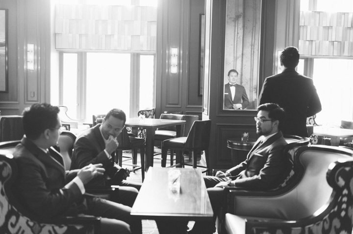 Groom and groomsmen hang out in the lounge of the Ritz Carlton in San Francisco, CA. Captured by NYC wedding photographer Ben Lau.