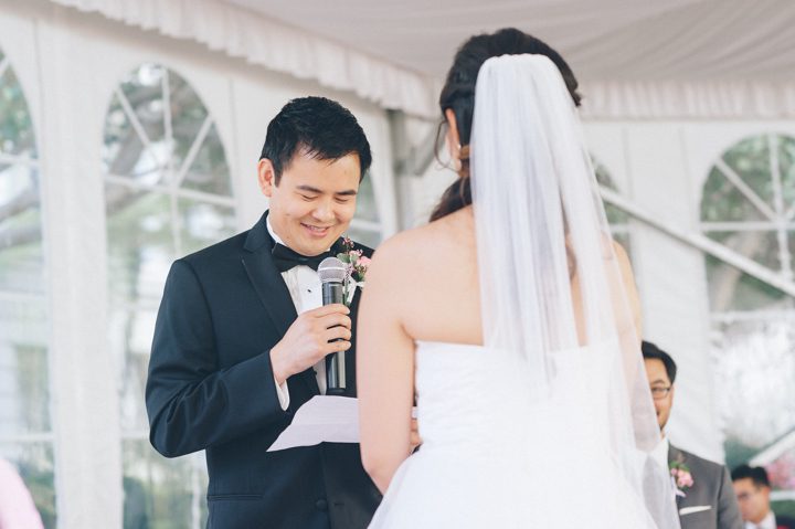 A groom recites his vows during his wedding ceremony at the Ritz Carlton in San Francisco, CA. Captured by NYC wedding photographer Ben Lau.