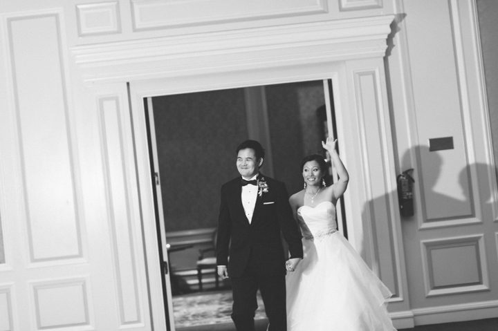 Grand entrance of the bride and groom during their wedding reception at the Ritz Carlton in San Francisco, CA. Captured by NYC wedding photographer Ben Lau.