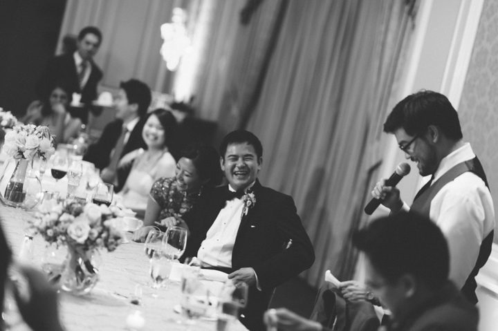 Bride and groom react during speeches at their wedding reception at the Ritz Carlton in San Francisco, CA. Captured by NYC wedding photographer Ben Lau.