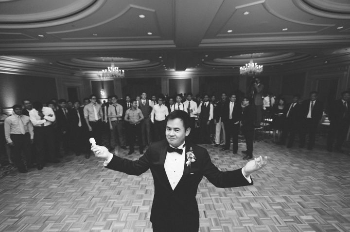 Garter toss during a wedding reception at the Ritz Carlton in San Francisco, CA. Captured by NYC wedding photographer Ben Lau.