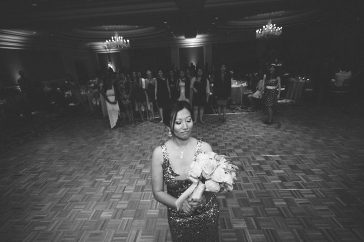Bouquet toss during a reception at the Ritz Carlton in San Francisco, CA. Captured by NYC wedding photographer Ben Lau.