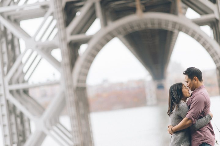 Cheryl and Jon pose under the GW Bridge during their engagement session with NYC wedding photographer Ben Lau.