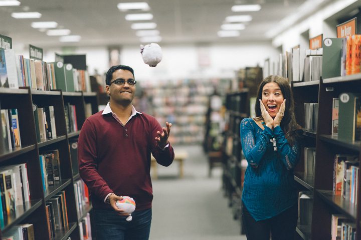Tivoli and David pose during their engagement session inside a book store in Long Island, NY. Captured by NYC wedding photographer Ben Lau.