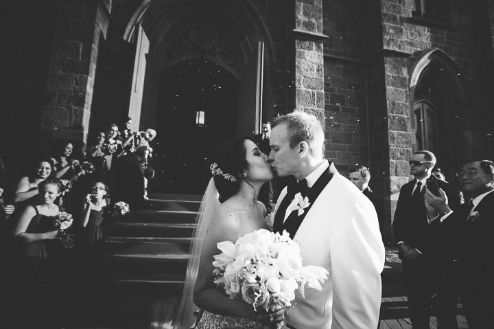 Bride and groom kiss outside of a church in Somerset, NJ. Captured by NJ wedding photographer Ben Lau.