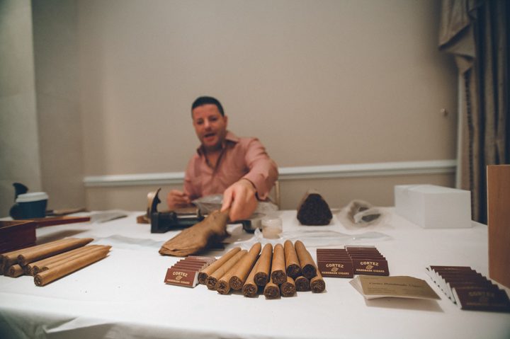Cortez Cigars rolls cigars for guests for a wedding at The Palace at Somerset Park, NJ. Captured by awesome NJ wedding photographer Ben Lau.