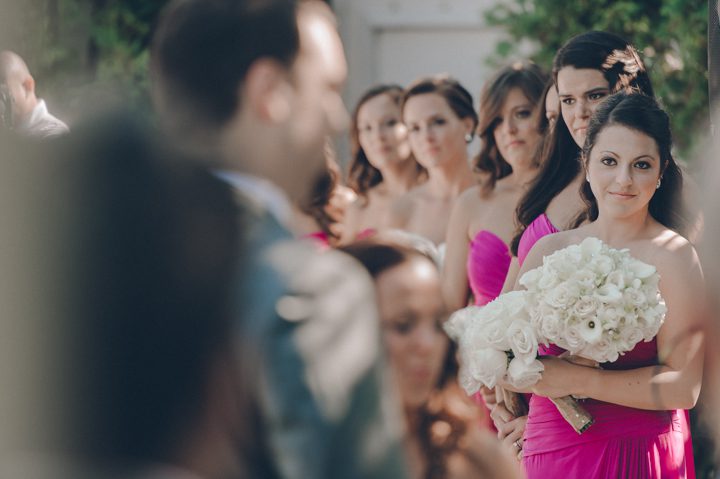 Bridesmaids look on during a Westmount Country Club wedding ceremony in Woodland Park, NJ. Captured by awesome NJ wedding photographer Ben Lau.