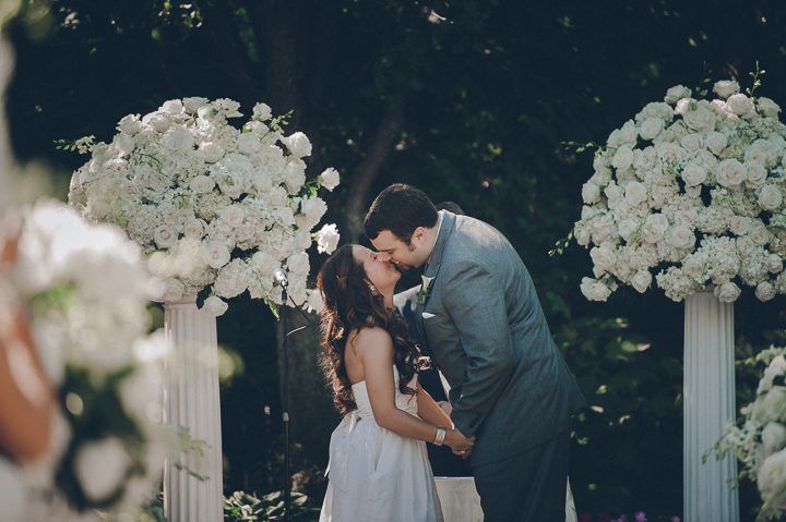 Bride and groom kiss during their wedding ceremony at the Westmount Country Club. Captured by awesome NJ wedding photographer Ben Lau.