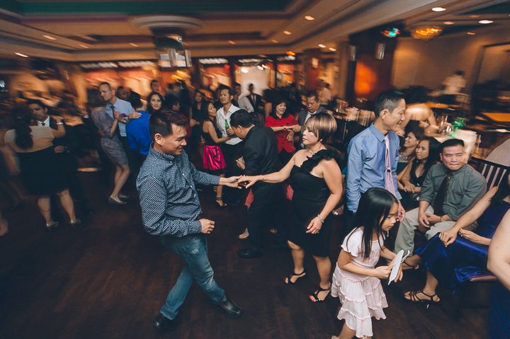 Guest dance during a wedding reception at China Garden in Rosslyn, Northern Virginia. Captured by NYC wedding photographer Ben Lau.