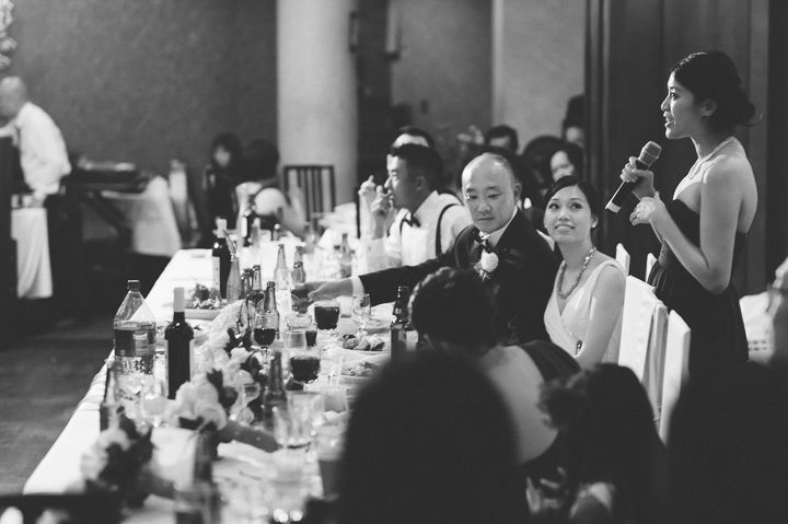 Maid of honor makes a toast during a wedding reception at China Garden in Rosslyn, Northern Virginia. Captured by NYC wedding photographer Ben Lau.