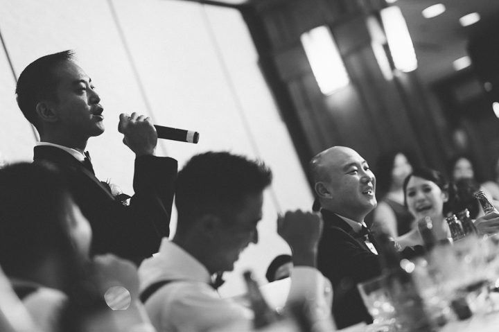 Best man makes a toast during a wedding reception at China Garden in Rosslyn, Northern Virginia. Captured by NYC wedding photographer Ben Lau.