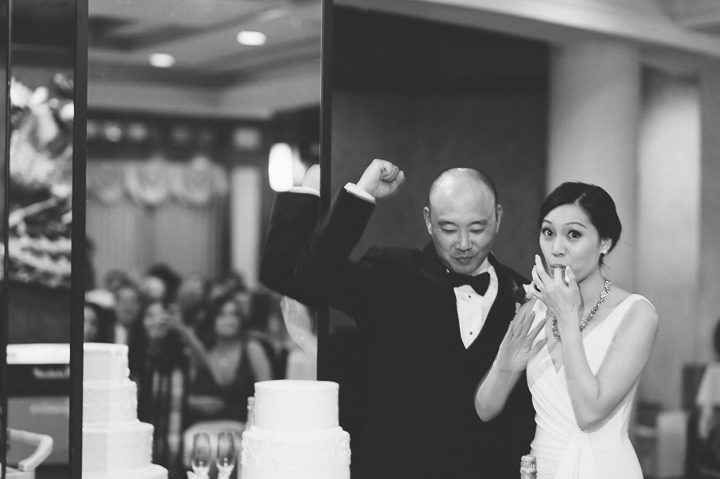 Cake cutting during a wedding reception at China Garden in Rosslyn, Northern Virginia. Captured by NYC wedding photographer Ben Lau.