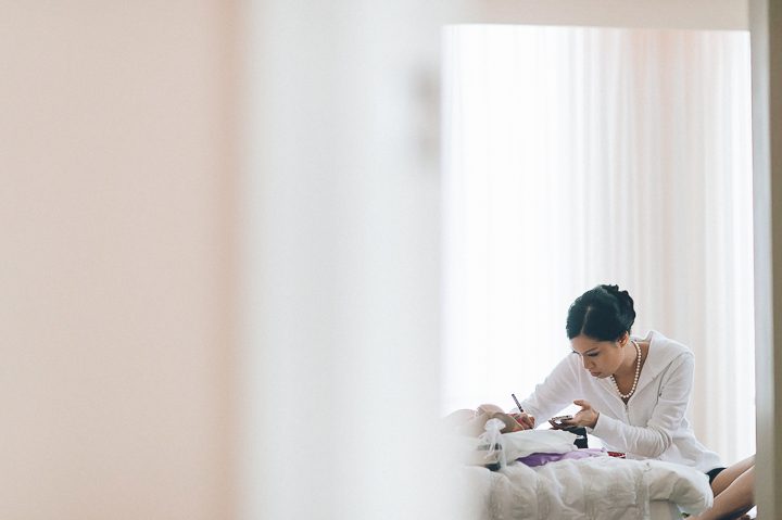 Bride writes a note on the morning of her wedding at the Le Meridian in Crystal City - Northern Virginia. Captured by NYC wedding photographer Ben Lau.