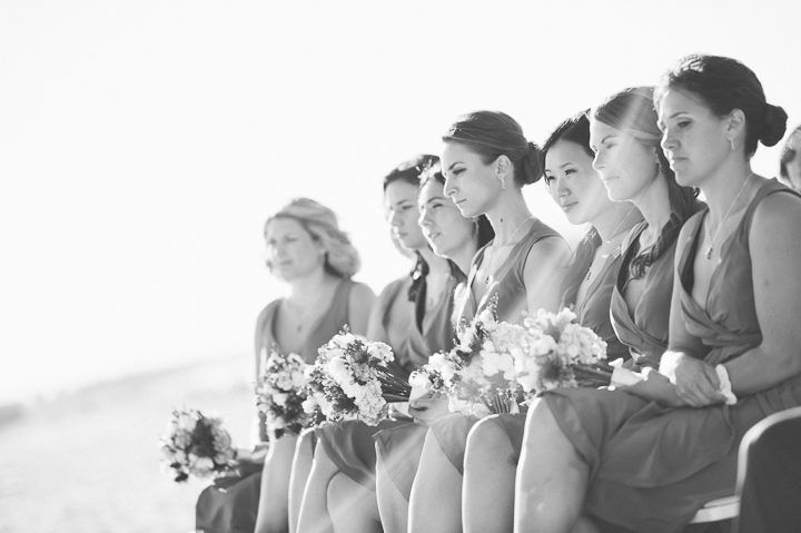 Bridesmaids during a beach wedding ceremony at Westhampton Bath & Tennis in Westhampton, NY. Captured by NYC wedding photographer Ben Lau.