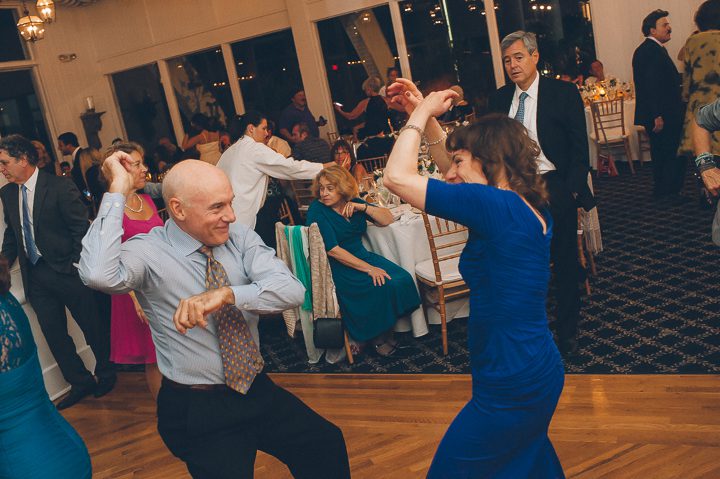 Guests dance during a wedding reception at Oceanblue/Westhampton Bath & Tennis in Westhampton, NY. Captured by NYC wedding photographer Ben Lau.