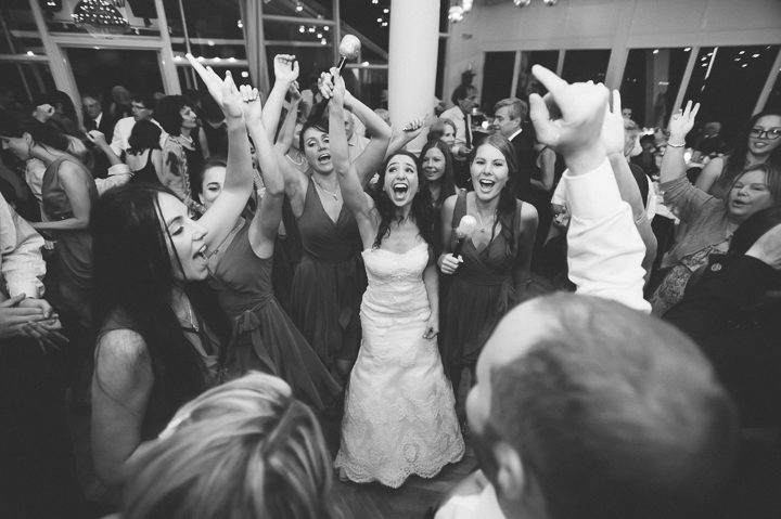 Bride sings with her guests during her wedding reception at Oceanblue/Westhampton Bath & Tennis in Westhampton, NY. Captured by NYC wedding photographer Ben Lau.
