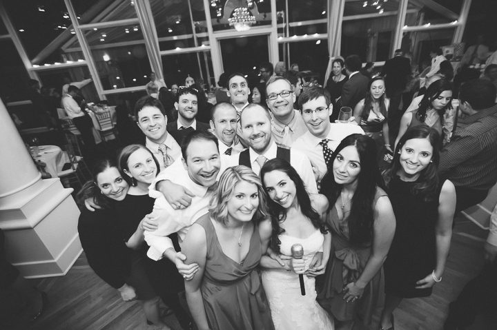 Wedding guests pose for a photo at Oceanblue/Westhampton Bath & Tennis in Westhampton, NY. Captured by NYC wedding photographer Ben Lau.