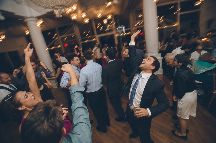 Brother of the bride dances during a reception at Oceanblue/Westhampton Bath & Tennis in Westhampton, NY. Captured by NYC wedding photographer Ben Lau.