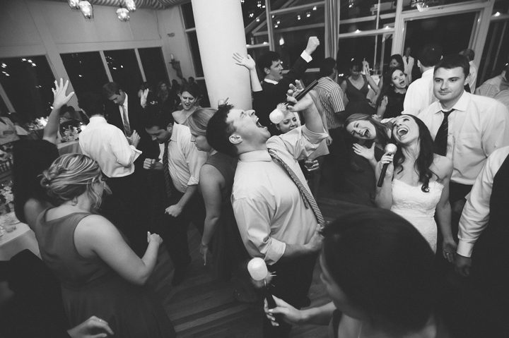 Guests dance during a reception at Oceanblue/Westhampton Bath & Tennis in Westhampton, NY. Captured by NYC wedding photographer Ben Lau.