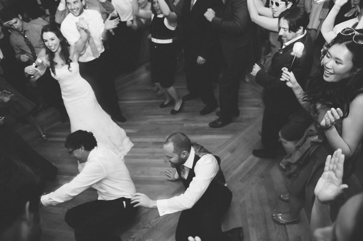 Groom dances on the floor during his wedding reception at Oceanblue/Westhampton Bath & Tennis in Westhampton, NY. Captured by NYC wedding photographer Ben Lau.