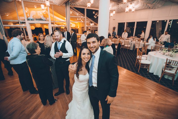 Bride and her brother pose for a photo during her wedding reception at Oceanblue/Westhampton Bath & Tennis in Westhampton, NY. Captured by NYC wedding photographer Ben Lau.