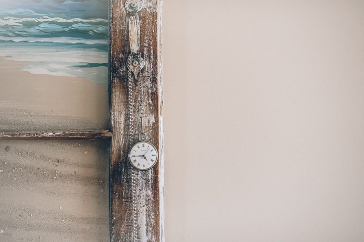 Pocketwatch hangs in the doorway of the bridal suite  at Oceanbleu in Westhampton, NY. Captured by NYC wedding photographer Ben Lau.