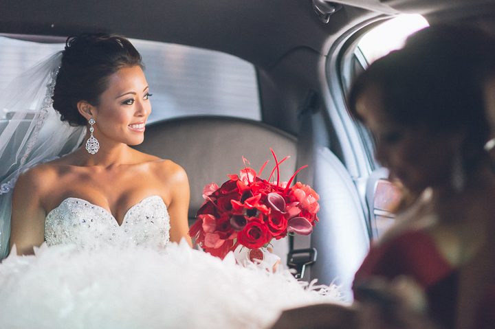 Bride looks out the window of her limo, while en route to the Belvedere Hotel in Baltimore, MD. Captured by NYC wedding photographer Ben Lau.