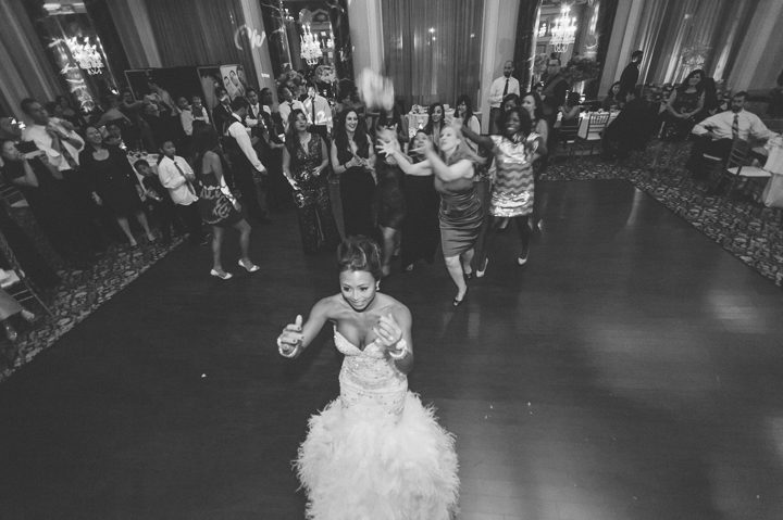Bouquet toss during a wedding reception at the Belvedere Hotel. Captured by NYC wedding photographer Ben Lau.