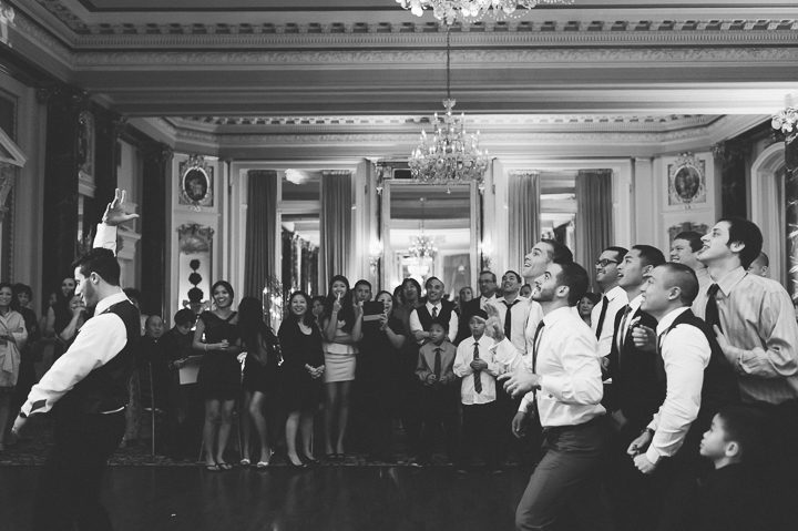 Garter toss during a wedding reception at the Belvedere Hotel. Captured by NYC wedding photographer Ben Lau.