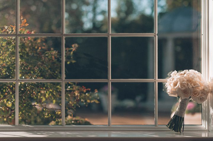 Flowers by the window at The Estate at Florentine Gardens in River Vale, NJ. Captured by Northern NJ wedding photographer Ben Lau.