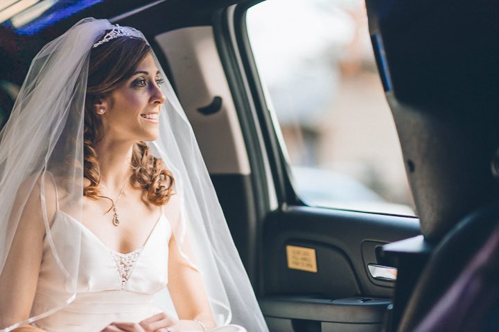 Bride rides the limo on her way to St. John's University and Glen Cove Mansion. Captured by NYC wedding photographer Ben Lau.