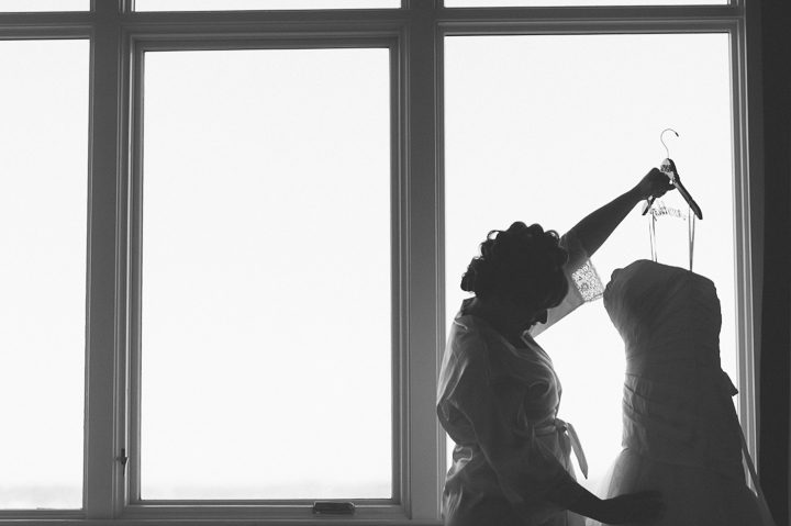 Bride looks at her dress at the Bungalow Hotel in Long Branch, NJ. Captured by NYC wedding photographer Ben Lau.