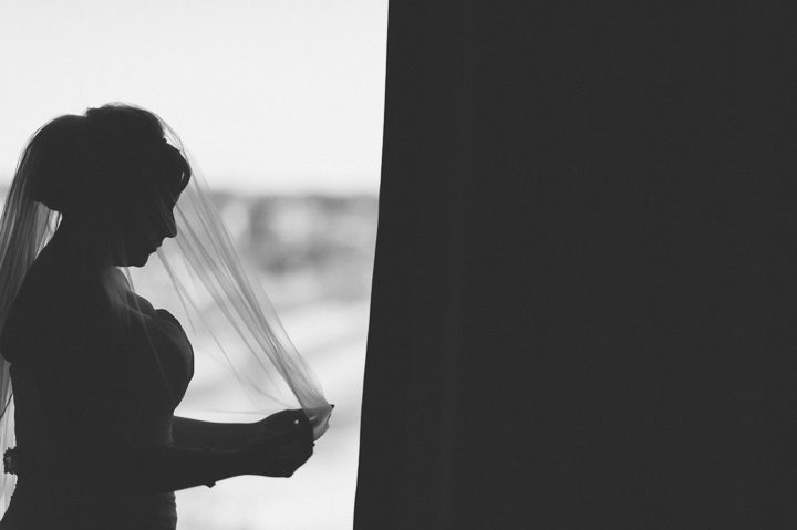 Bride's silhouette by the window. McLoones Pierhouse Wedding in Long Branch, NJ. Captured by NYC wedding photographer Ben Lau.