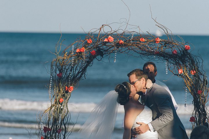 Bride and groom during their beach wedding at McLoones Pierhouse Wedding in Long Branch, NJ. Captured by NYC wedding photographer Ben Lau.