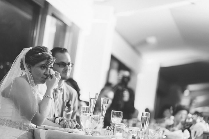 Bride and groom reacts during speeches at a McLoones Pierhouse Wedding in Long Branch, NJ. Captured by NYC wedding photographer Ben Lau.