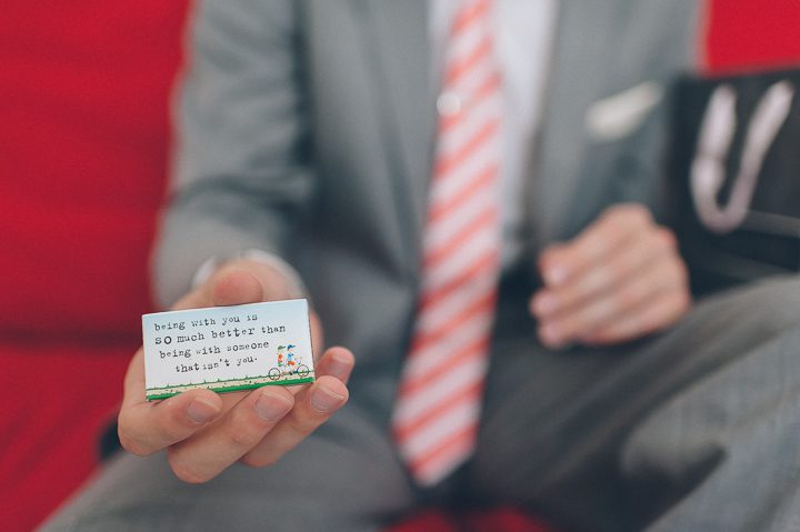 Groom shows writing on a matchbox at the Bungalow Hotel for a McLoone's Pier House Wedding in Long Branch, NJ. Captured by NYC wedding photographer Ben Lau.
