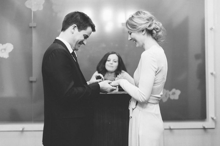 Bride and groom exchanging rings during their New York City Hall wedding, captured by NYC wedding photographer Ben Lau.