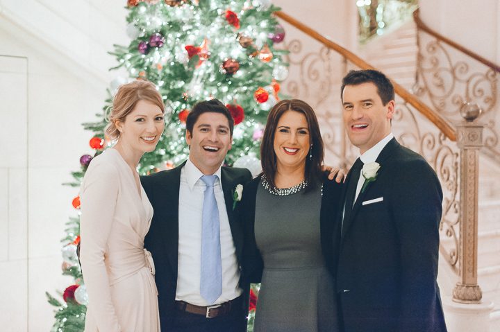Bride and groom pose with their friends in the Plaza Hotel after their New York City Hall wedding, captured by NYC wedding photographer Ben Lau.