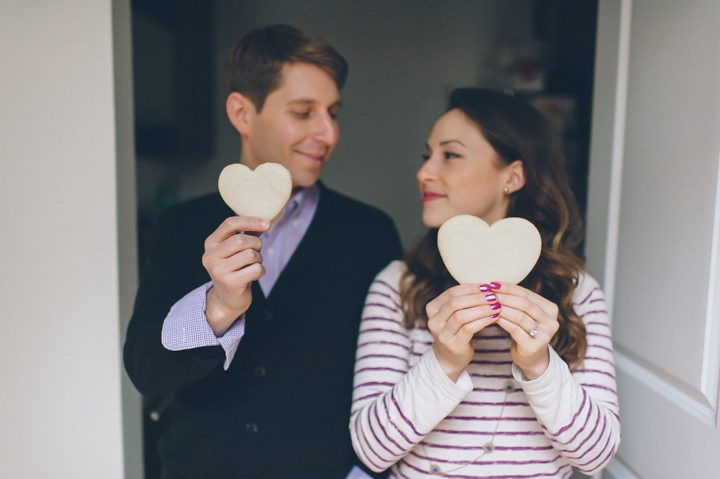 Zoie and Daniel bakes heart shaped cookies during their rainy day engagement session with New York City wedding photographer Ben Lau.