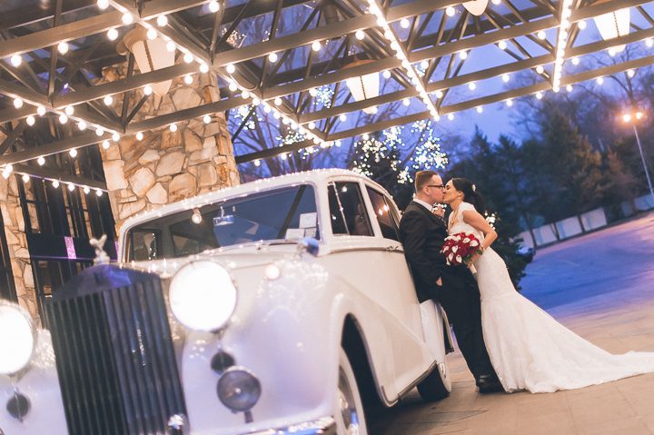 Bride and groom kiss in front of Crest Hollow Country Club. Captured by NYC wedding photographer Ben Lau.