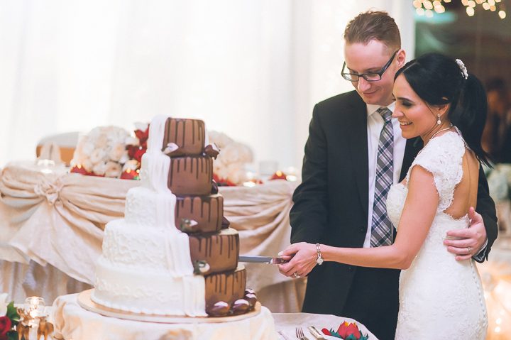 Cake cutting during a wedding ceremony at Crest Hollow Country Club wedding captured by NYC wedding photographer Ben Lau.