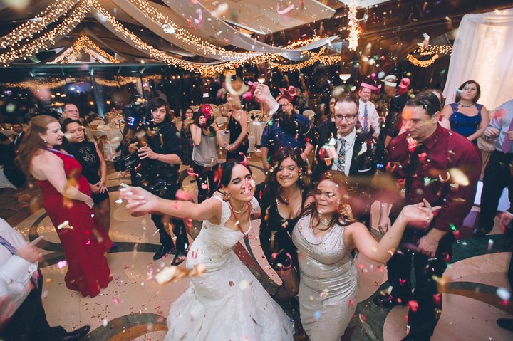 Guests dance at wedding reception at Crest Hollow Country Club. Captured by NYC wedding photographer Ben Lau.