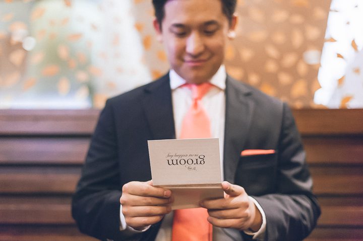 Groom reads a letter from the bride in his suite of the Sheraton Laguardia East in Flushing, NY. Captured by NYC wedding photographer Ben Lau.