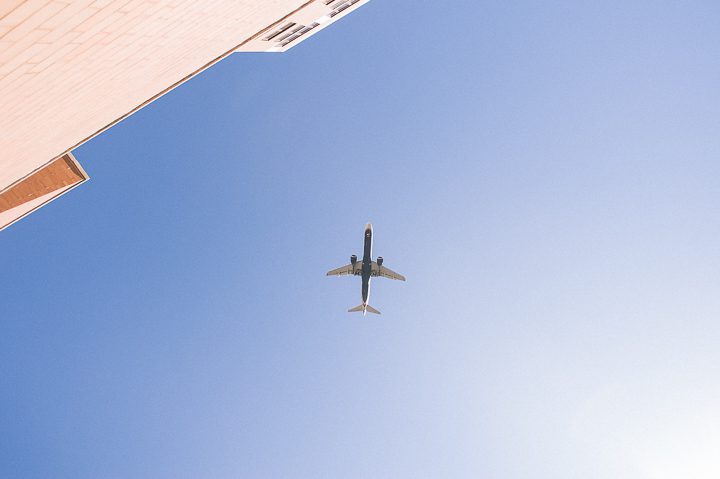 Plane flies overhead at the Sheraton Laguardia East in Flushing, NY. Captured by NYC wedding photographer Ben Lau.
