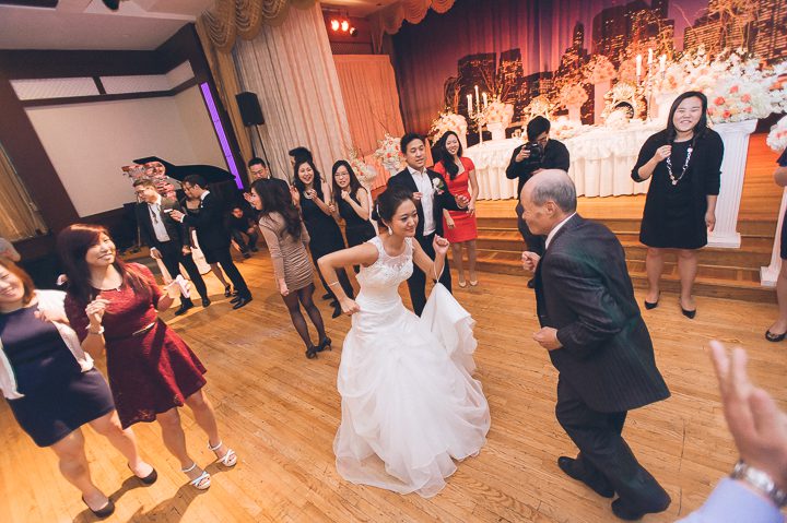 Guests dance during a wedding reception at Dae Dong Manor in Flushing, NY. Captured by NYC wedding photographer Ben Lau.