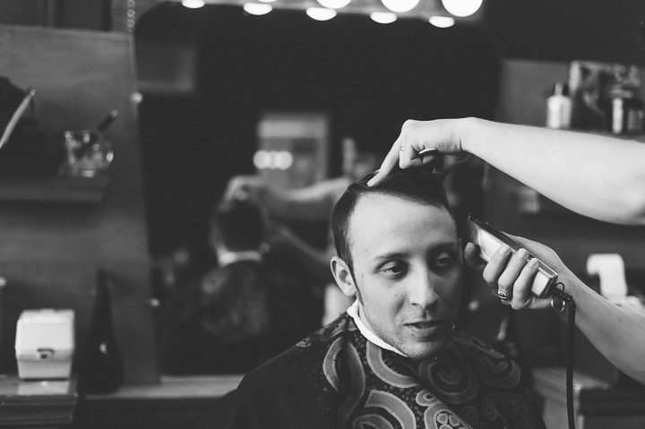 Groom gets a haircut on the morning of his wedding day at Kirkpatrick Chapel in New Brunswick, NJ. Captured by Central Jersey Wedding Photographer Ben Lau.