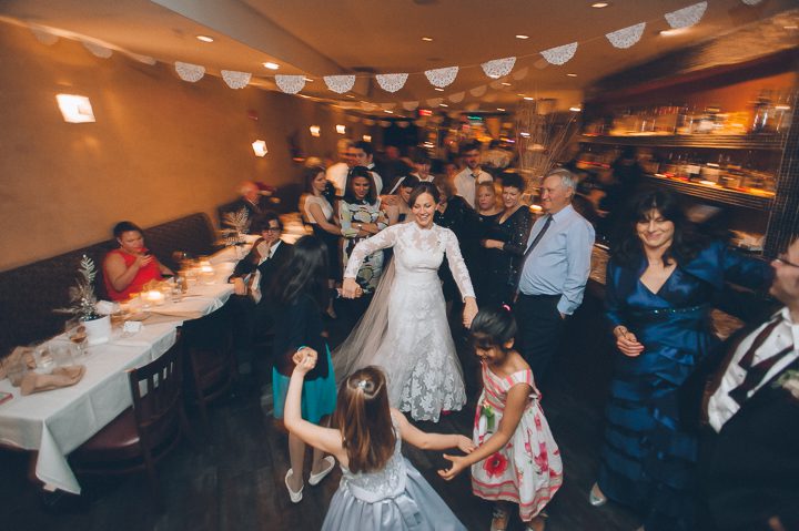 Guests dance during wedding at Tula's Lounge in New Brunswick, NJ. Captured by Central Jersey Wedding Photographer Ben Lau.