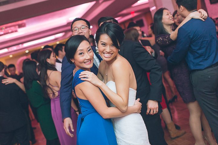 Guests pose for photos during a wedding reception at Mudan's in Flushing Queens. Captured by NYC wedding photographer Ben Lau.