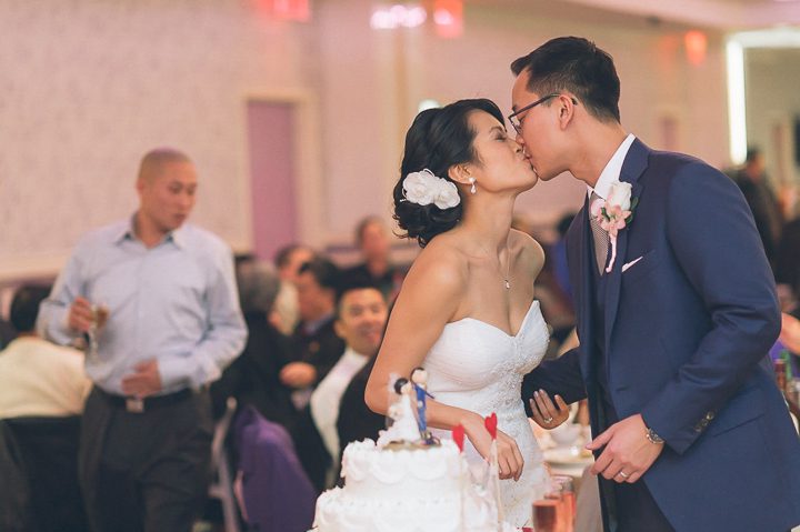 Cake cutting during a wedding reception at Mudan's. Captured by NYC wedding photographer Ben Lau.